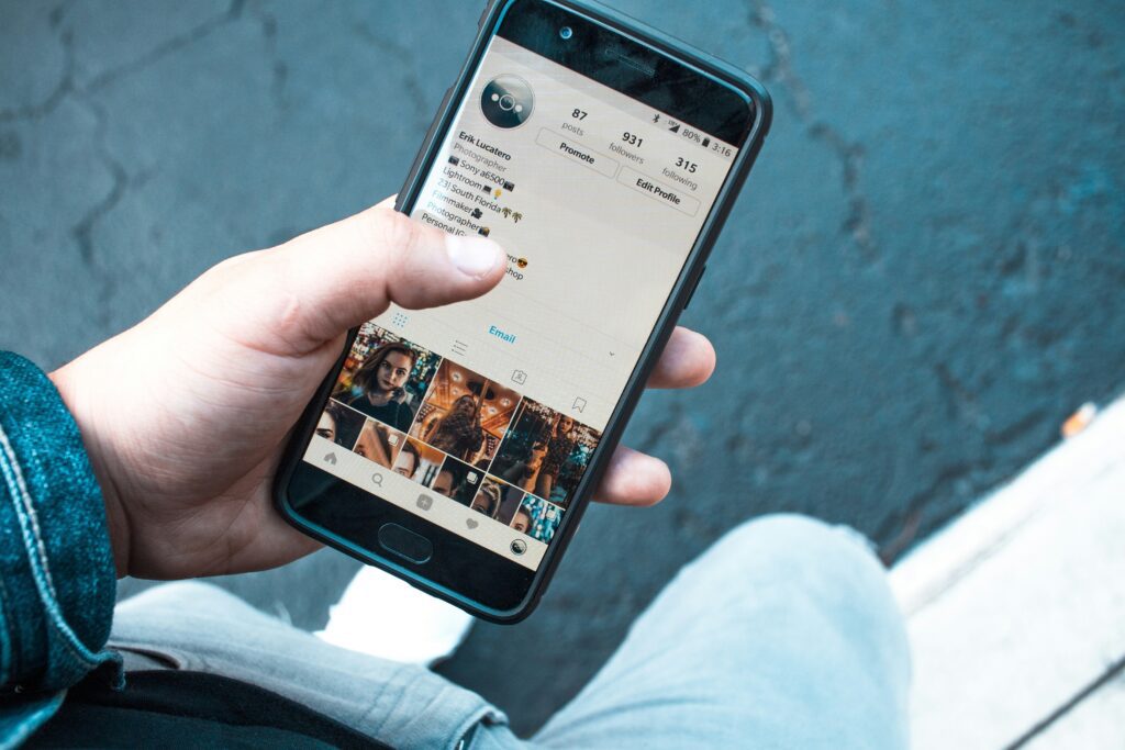 person scrolling on a phone displaying a social media platform