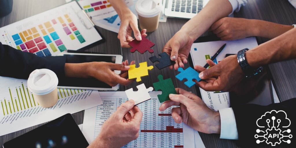 hands holding puzzle pieces together over a meeting room table