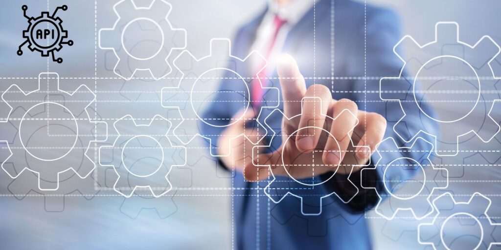 man pointing toward cogs on screen