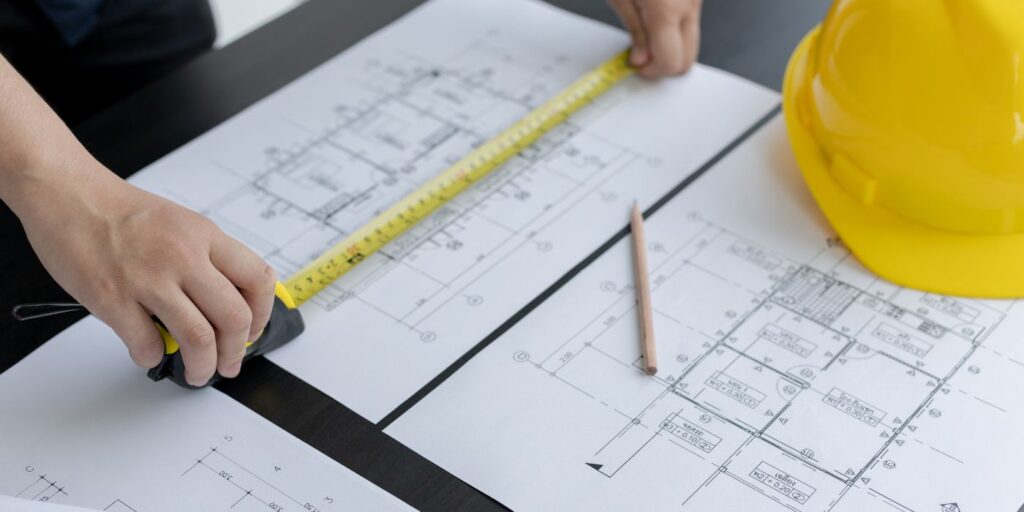 person doing construction management on paper