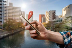 man holding phone with google maps point icon above it showing hyperlocal search