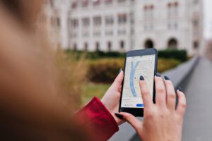 woman looking up google maps on phone
